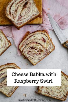 cheese babka with raspberry swirl on a cutting board next to sliced bread