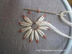 a close up of a piece of cloth with flowers on it and wires attached to the fabric