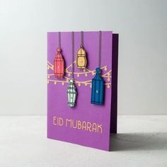 a purple card with three paper lanterns hanging from it's sides and the words, ed murbak