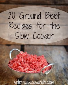 a metal bowl filled with ground beef on top of a wooden table next to a sign that reads, 20 ground beef recipes for the slow cooker