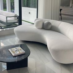 a white couch sitting on top of a hard wood floor