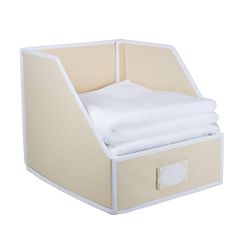 an empty storage box with folded white towels in the bottom and two folded sheets on top