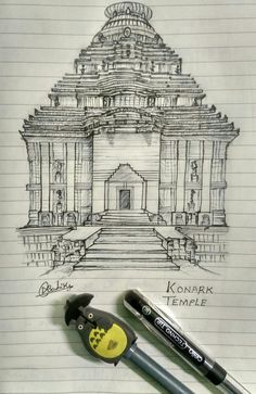 some pens are sitting on top of a piece of paper with a drawing of a building in the background