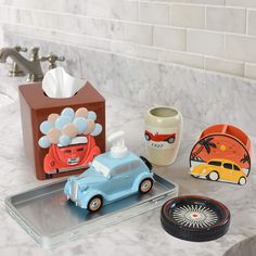 a bathroom counter with soap dispenser, toothbrush holder and toy cars on it