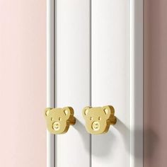 there are two teddy bears on the door knobs