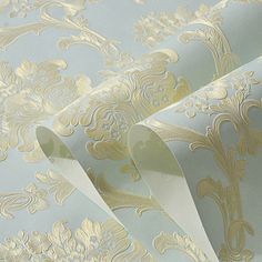 a wallpaper with gold and silver designs on it