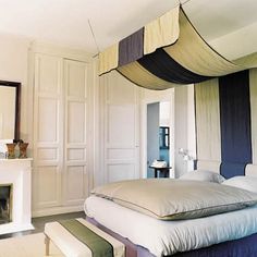 a bedroom with a canopy bed and fireplace