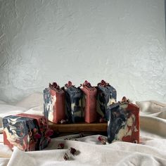 four soap bars sitting on top of each other with flowers around them and one bar of soap in the middle