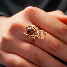 This beautiful Spider ring is made of Sterling Silver and coated with a thick layer of 24K Yellow Gold and features a natural pear-shaped Garnet Cabochon. 24K Gold Plated jewelry pieces are hypoallergenic and they also do not tarnish.   Our rings are meticulously handcrafted and hand-polished to perfection. They are made to last a lifetime with proper care.   Please note: Due to the one-of-a-kind nature of the gemstones, exact colors and patterns may vary slightly from the image shown. Please re Spider Accessories, Flame Ring, Spider Ring, Gemstone Stacking Ring, Jewelry Goth, Spider Jewelry, Crystal Aesthetic, Ear Climbers Earrings, Wearable Art Jewelry