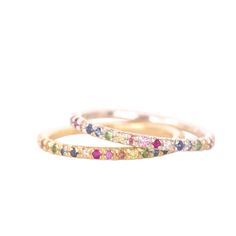 Please note our small workshop is closed for a summer break, so orders placed now will be delivered around 20th September.  Beautiful and elegant sterling silver or 14ct gold rainbow eternity ring, featuring a kaleidoscope of gemstones, made up of pink, white, yellow, orange and blue sapphires, rubies and green tsavorites.  Available in either a half eternity ring or full eternity ring.  Details:  Material: 14ct Gold | AU585 or Sterling Silver | AG925 Gemstone: 0.15ct (half eternity ring) Gemstones: 0.30ct (full eternity ring) Please note our small workshop is closed for a summer break, so any ring order placed now will not be delivered until early October. Sizes are listed as UK ring sizes, if you require a different size than those listed or want to order a US or European ring size pleas Rainbow Gemstone Stackable Rings For Anniversary, Rainbow Sapphire Ring Fine Jewelry Gift, Multicolor Sterling Silver Stackable Rings, Rainbow Sapphire Ring As Gift, Rainbow Sapphire Ring For Gift, Rainbow Multi-stone Stackable Promise Rings, Rainbow Multi-stone Stackable Rings For Promise, Multicolor Gemstone Eternity Band For Gift, Multicolor Gemstone Eternity Band As Gift