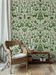 a chair and table in front of a wall with green christmas wallpaper on it