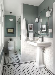 a bathroom with black and white floor tiles