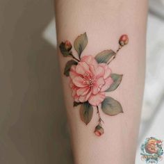 a pink flower tattoo on the left arm and leg, with green leaves around it