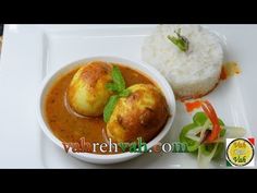 a white plate topped with two bowls filled with food