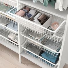 an organized closet with clothes and other items in baskets on the bottom shelf is shown