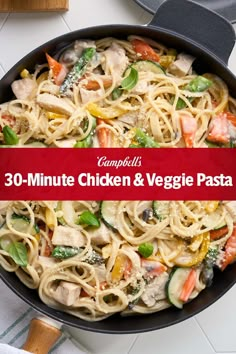 a pan filled with pasta and vegetables on top of a table