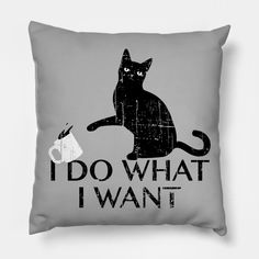 a black cat sitting on top of a pillow with the words i do what i want