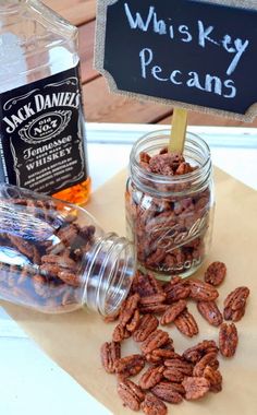 some nuts are sitting on a table next to a sign that says whiskey pecans