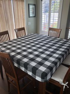 a dining room table with a black and white checkered tablecloth on the table