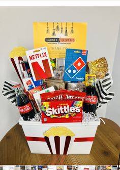 a popcorn bucket filled with snacks and drinks