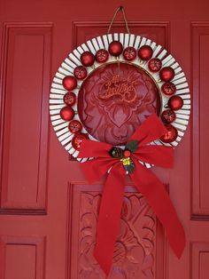 a red door with a wreath and ornaments on it