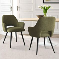 two green chairs sitting next to each other on top of a white carpeted floor