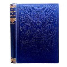 a blue book with an intricate design on the front and back cover, in gold trimming