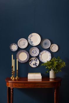 a table topped with plates and a vase filled with flowers