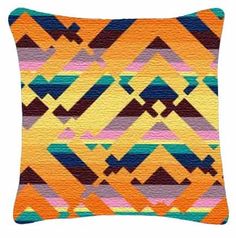 an orange and purple pillow with geometric designs on it