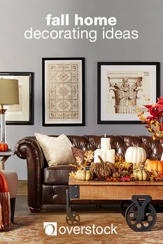 a living room filled with furniture and lots of fall decorations on top of a coffee table