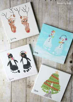 four handprinted christmas cards are displayed on a wooden surface with the words family deer and penguin