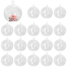 twelve clear glass ornaments with a rose in the center and eight round ones on each side