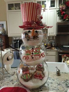 a snowman made out of candy in a bowl on top of a kitchen counter