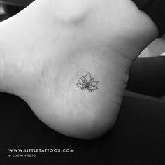 a small lotus flower tattoo on the foot