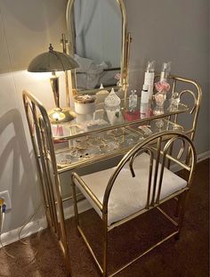 a vanity with a mirror, stool and lights