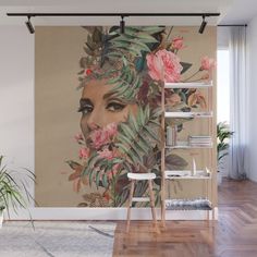 a woman's face surrounded by flowers and leaves on a beige background wall mural