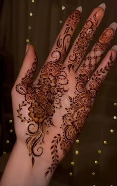 the hand is decorated with henna designs