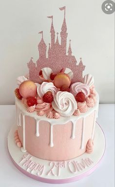 a pink cake with white frosting and decorations