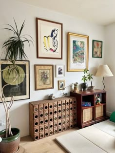 a living room filled with furniture and pictures on the wall