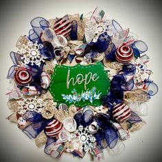 a wreath with the word hope written on it and decorations around it in red, white, and blue colors