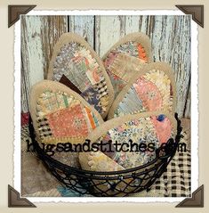 a basket filled with lots of different pieces of fabric on top of a wooden table