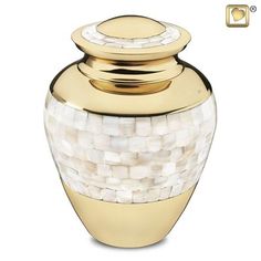 a gold and white urn with a lid