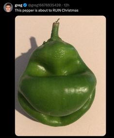 a green pepper sitting on top of a white counter