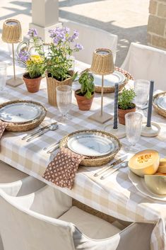 the table is set with dishes and place settings