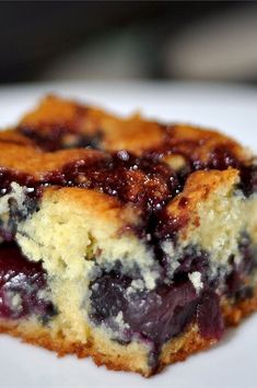 a piece of blueberry cheesecake on a white plate