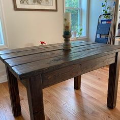 a wooden table sitting on top of a hard wood floor