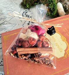 a bag filled with nuts and cinnamons sitting on top of a table next to an orange book