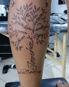 a woman's leg with a tree tattoo on it and words written in cursive writing