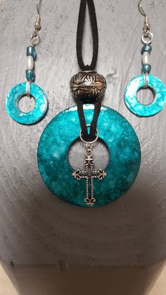 a necklace and earring set made with glass beads, leather cord and metal clasps