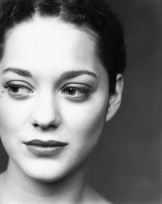 a black and white photo of a woman's face with eyeliners on